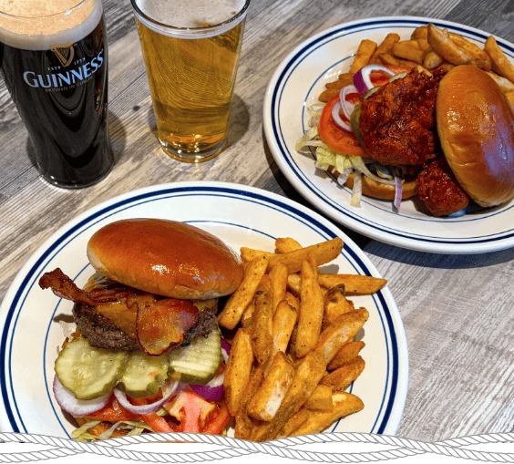plates of burgers and fries with glasses of beer at the Crafty Buffalo
